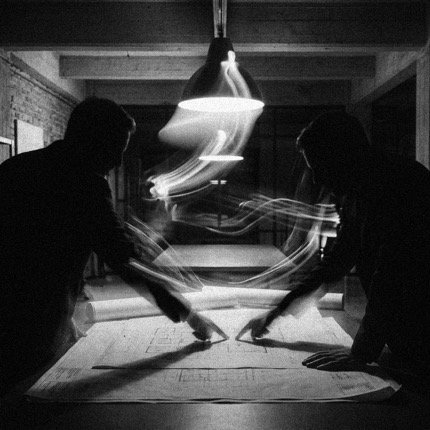 Two people conferring over blueprints